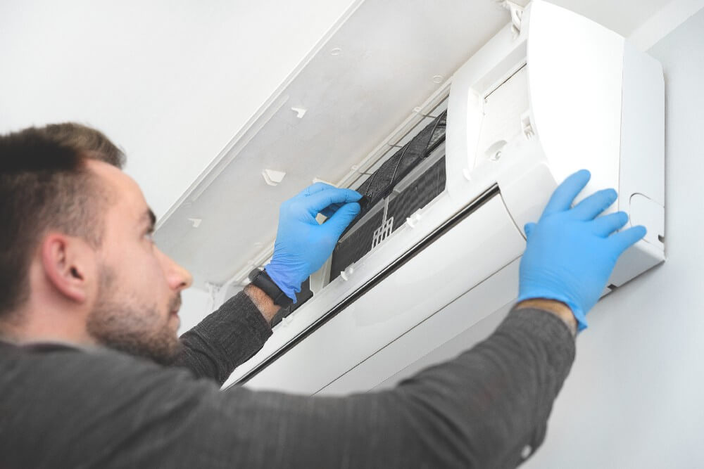 Technician replacing filet in air conditioner