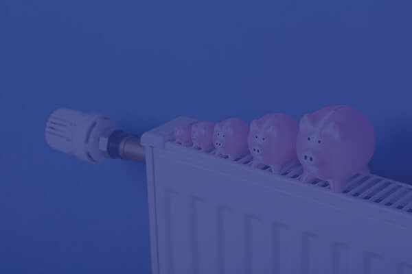 pig shaped money banks lined up on a radiator